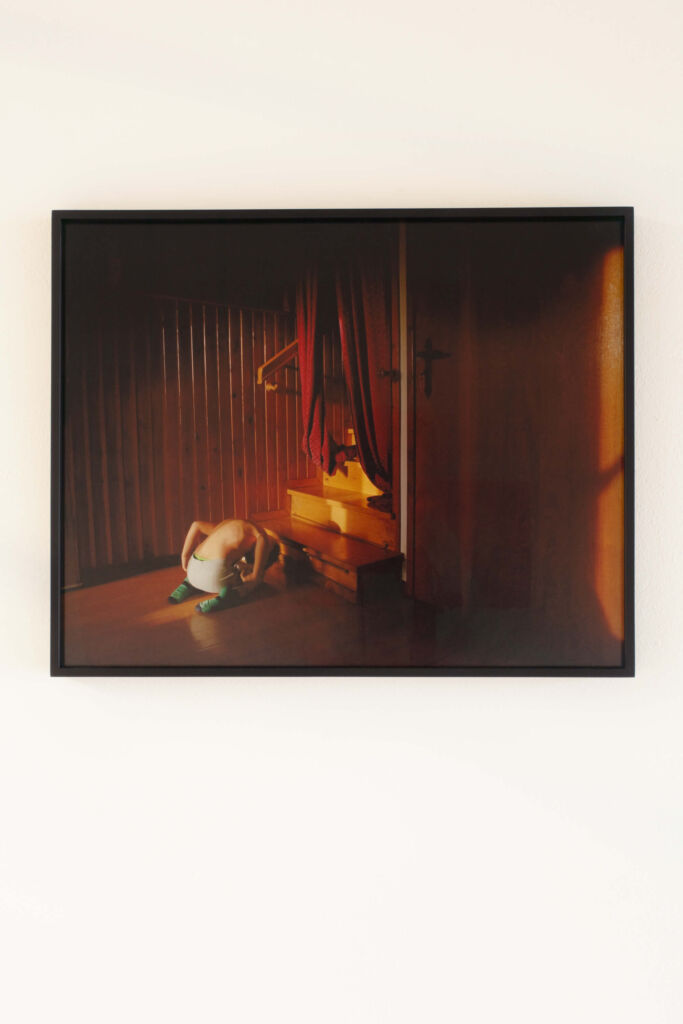 A framed photograph of a woman laying on the floor.